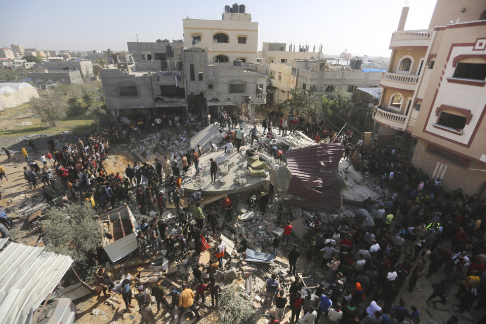 Palestinians look for survivors after an Israeli strike on the Gaza Strip in Rafah on Saturday, Nov. 23, 2023. (AP Photo/Hatem Ali)