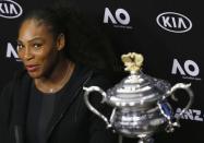 Tennis - Australian Open - Melbourne Park, Melbourne, Australia - 28/1/17 Serena Williams of the U.S. reacts next to the Women's singles trophy during her post-match news conference. REUTERS/Issei Kato