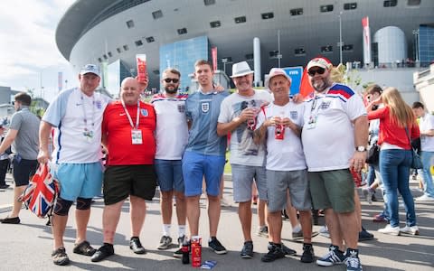 Kevin Monks, in blue, and his group of England fans make their way into the last match of the tournament - Credit: Julian Simmonds/For The Telegraph