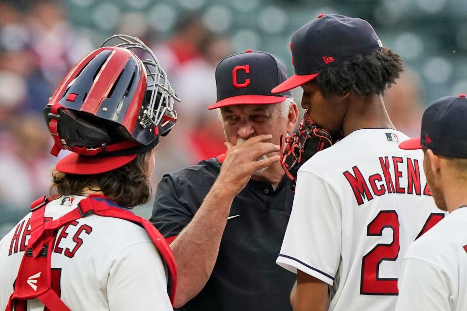 Cleveland pitching coach Carl Willis, center, taels with starting pitcher Triston McKenzie, right, and catcher Austin Hedges in the fourth inning of a baseball game, Friday, May 21, 2021, in Cleveland. (AP Photo/Tony Dejak)