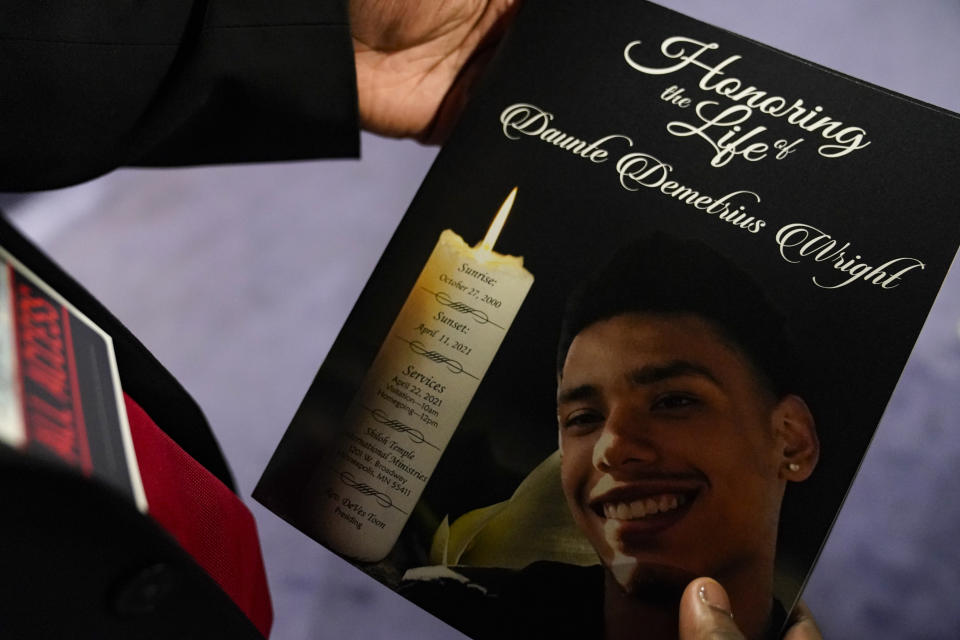 This April 22, 2021 file photo shows a mourner holding the program for the funeral services of Daunte Wright at Shiloh Temple International Ministries in Minneapolis. Minnesota Attorney General Keith Ellison says his office will lead the prosecution of former Brooklyn Center Officer Kim Potter who is charged with second-degree manslaughter in the death of Daunte Wright. Potter, who is white, fatally shot Wright, a 20-year-old Black motorist, on April 11, 2021. (AP Photo/John Minchillo, Pool, File)