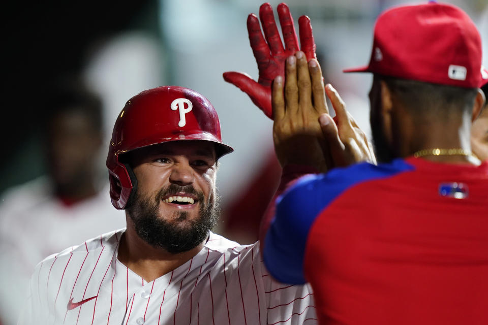 Philadelphia Phillies' Kyle Schwarber celebrates with teammates in the dugout after hitting a home run against Washington Nationals pitcher Josiah Gray during the sixth inning of a baseball game, Wednesday, July 6, 2022, in Philadelphia. (AP Photo/Matt Slocum)