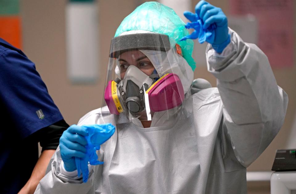 A registered nurse makes her way to a patient's room inside the coronavirus unit at Houston's United Memorial Medical Center. If the coronavirus is airborne, as many scientists say it is, health experts urge the use of masks and air filtration systems to help prevent virus transmission. (ASSOCIATED PRESS)