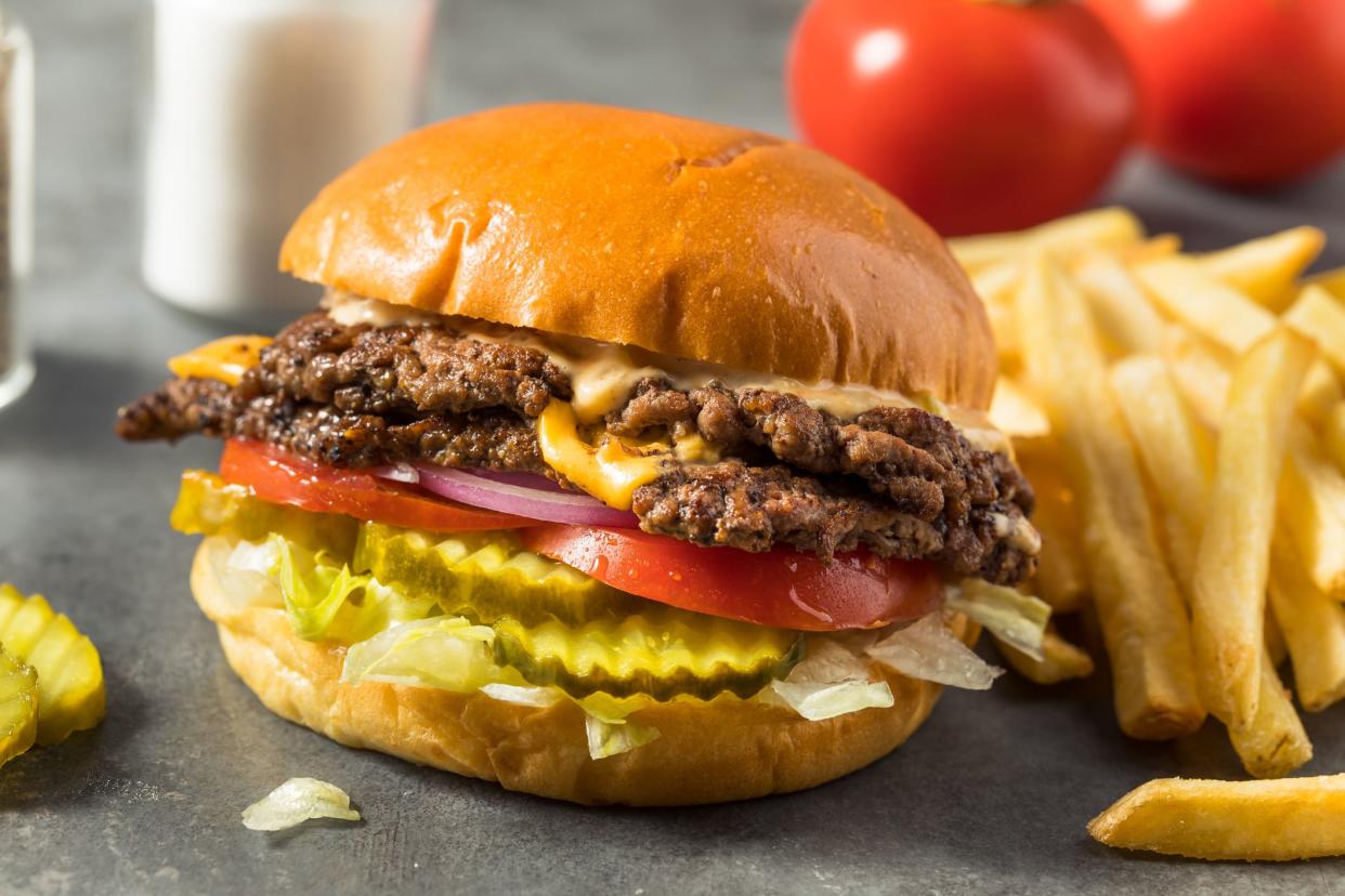 Homemade Cheese Smash Burger with Fries Pickles and Tomatoes