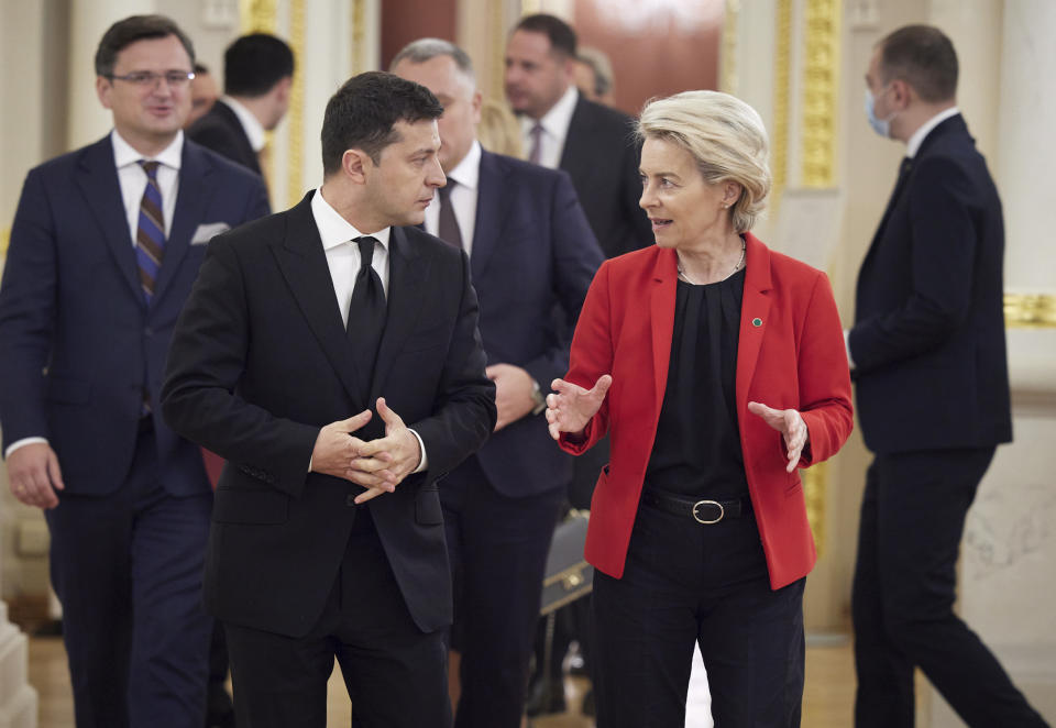 Ukrainian President Volodymyr Zelenskyy, left, and European Commission President Ursula von der Leyen share a word as they meet on the occasion of a Ukraine EU summit, in Kyiv, Ukraine, Oct. 12, 2021. The 23rd summit between the European Union and Ukraine is held in Kyiv. (Ukrainian Presidential Press Office via AP)