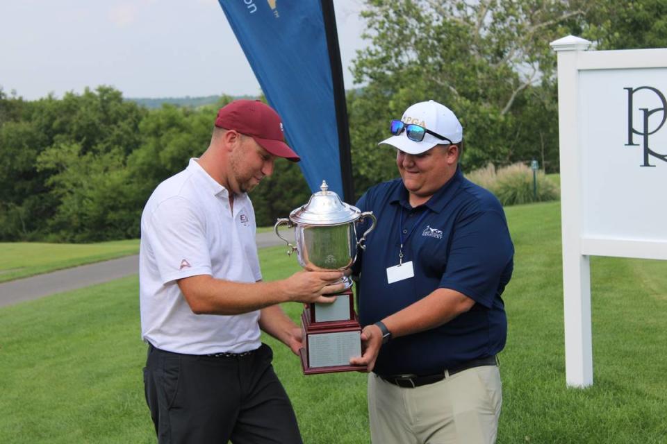 Eastern Kentucky University men’s golf head coach Justin Tereshko receives a trophy for winning the 104th Kentucky Open last week at Persimmon Ridge Golf Club in Louisville. Tereshko was a two-time All-America golfer during his college career at Transylvania University in Lexington.