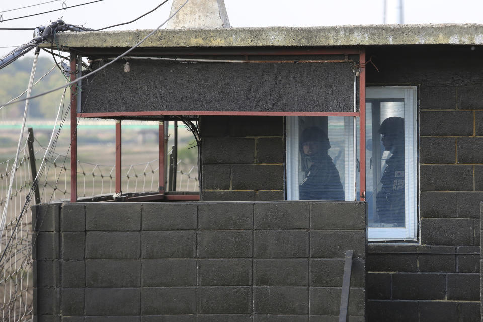 Army soldiers stand guard inside a military guard post in Paju, South Korea, near the border with North Korea, Sunday, May 3, 2020. North and South Korean troops exchanged fire along their tense border on Sunday, the South's military said, blaming North Korean soldiers for targeting a guard post. (AP Photo/Ahn Young-joon)