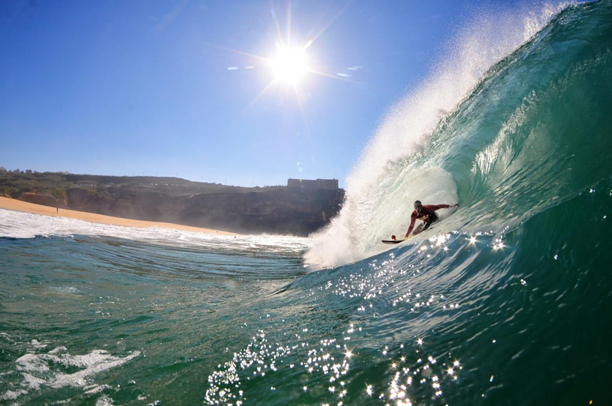 Surfing legend Garrett McNamara rides a wave off Nazare, Portugal, in a scene from Season 2 of "100 Foot Wave."