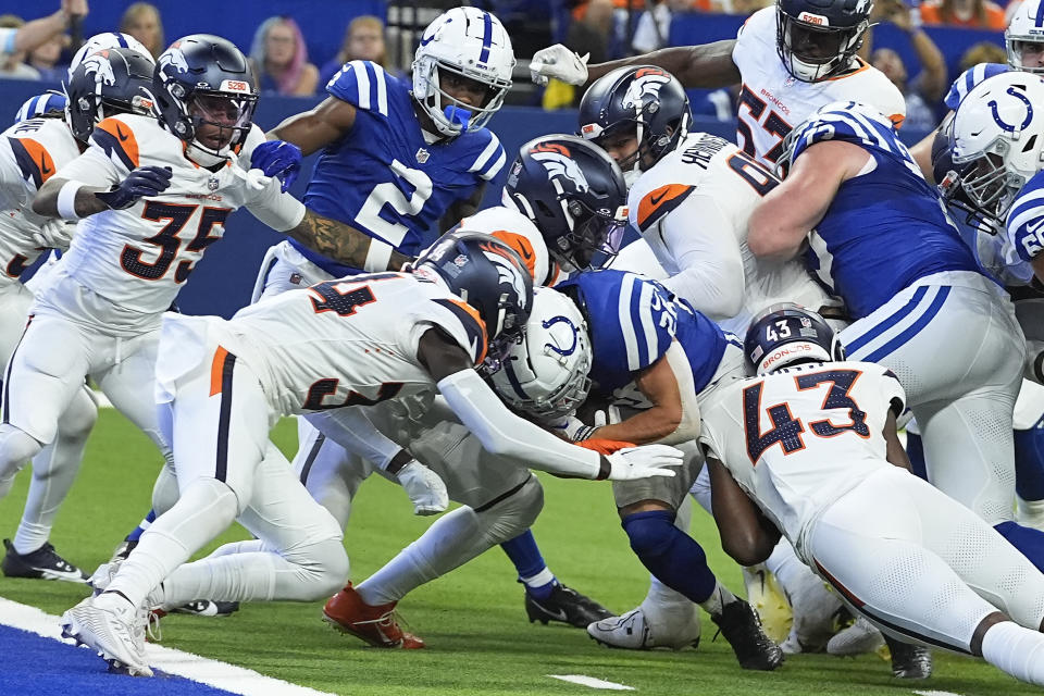 Indianapolis Colts running back Evan Hull (26) carries the ball for a touchdown against the Denver Broncos during the second quarter of a preseason NFL football game, Sunday, Aug. 11, 2024, in Westfield, Ind. (AP Photo/Darron Cummings)