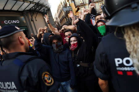 Catalan separatist protesters shout in front of Mossos d'Esquadra police officers during a protest against a demonstration in support of the Spanish police units who took part in the operation to prevent the independence referendum in Catalonia on October 1, 2017, in Barcelona, Spain, September 29, 2018. REUTERS/Jon Nazca