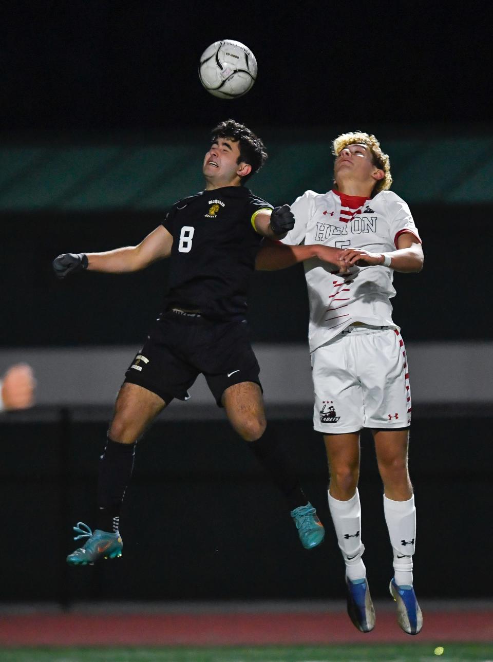 McQuaid's Marco Pilato, left, and Hilton's Logan Matthews jump for a header during a Section V Class AA semifinal, Thursday, Oct. 27, 2022. McQuaid advanced to the Class AA final with a 2-1 win over Hilton.