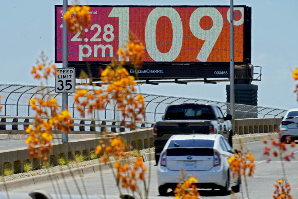 FILE - A digital billboard displays an unofficial temperature, Monday, July 17, 2023, in downtown Phoenix. A historic heat wave that turned the Southwest into a blast furnace throughout July is beginning to abate with the late arrival of the monsoon rains. Forecasters expect that by Monday, July 31, at the latest, people in metro Phoenix will begin seeing high temperatures under 110 degrees Fahrenheit (43.3 degrees Celsius) for the first time in a month. (AP Photo/Matt York, File)