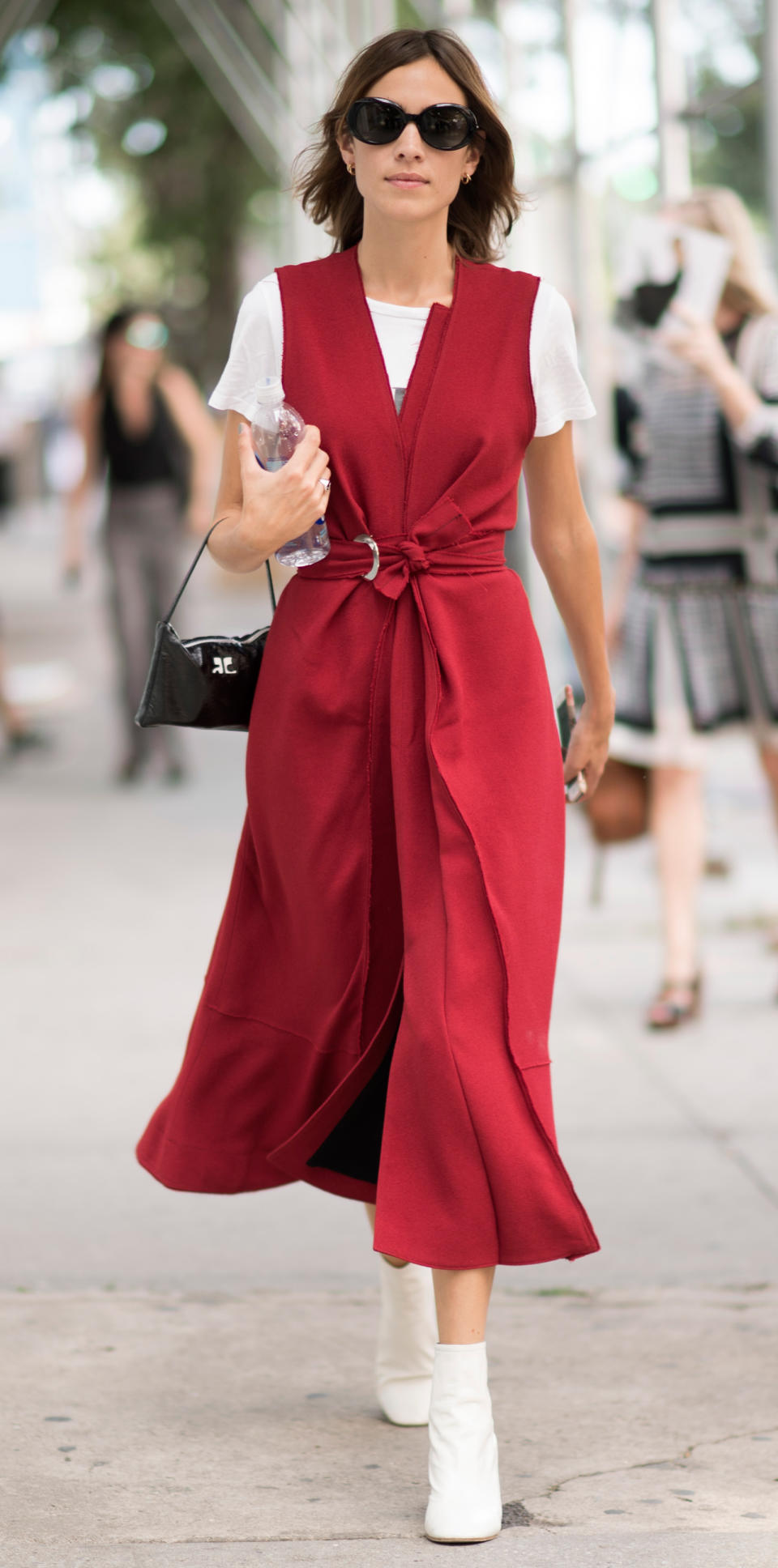 <p>We are loving Chung's fire engine red wrap dress, worn over a white tee and paired with white booties and a small black purse. </p>