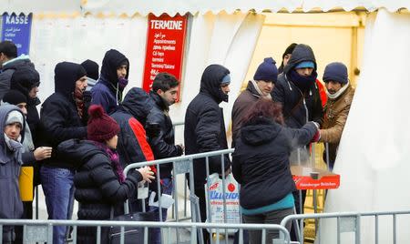 Migrants queue to enter a tent that serves as a waiting room at the the Berlin Office of Health and Social Affairs (LAGESO), in Berlin, Germany, January 5, 2016. REUTERS/Hannibal Hanschke