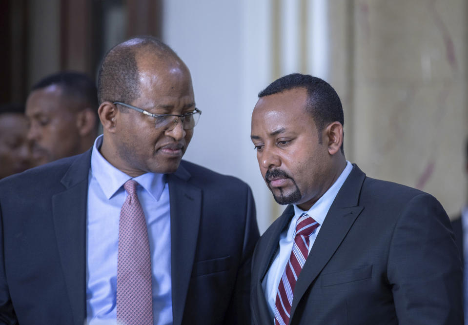 Tagesse Chafo Speaker of House of Representative, left, and Ethiopian Prime Minister Abiy Ahmed, right, leaving the parliament after addressing members of parliament on the current situation of the country in Addis Ababa, Ethiopia, Tuesday Oct. 22, 2019. Ethiopia's Nobel Peace Prize-winning prime minister is warning that if there's a need to go to war over a dam project disputed with Egypt his country could ready millions of people, but he says only negotiation can resolve the deadlock. (AP photo Mulugeta Ayene)