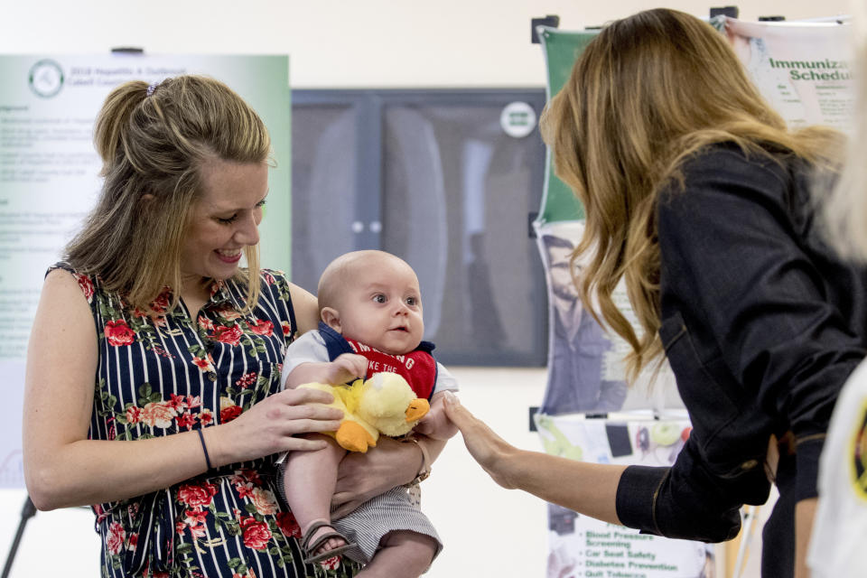 First lady Melania Trump meets with Megan Pawley, a mother in recovery, and her baby Huck Haynes at Cabell-Huntington Health Center in Huntington, WVa., Monday, July 8, 2019. Melania Trump is in Huntington to meet with state leaders on the ongoing opioid crisis. (AP Photo/Andrew Harnik)