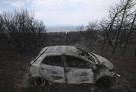 <p>A fire-damaged car is parked on a hill overlooking the village of Neos Voutzas near Athens, Tuesday, July 24, 2018. (Photo: Thanassis Stavrakis/AP) </p>