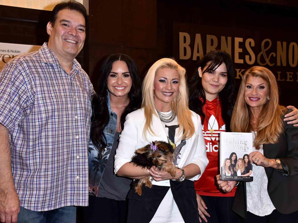 <p>Brandon Williams/Getty</p> Eddie De La Garza, Demi Lovato, Dallas Lovato, Madison De La Garza, and Dianna De La Garza at the signing of Dianna De La Garza