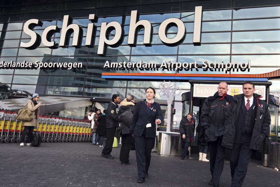 FILE This Saturday Dec. 26, 2009 file photo shows security workers leave Schiphol airport in Amsterdam, Netherlands. Police at Amsterdam's Schiphol Airport have opened a criminal investigation into how needles got into turkey sandwiches served to passengers on Delta Air Lines flights from Amsterdam to the United States, a spokesman said Tuesday July 17, 2012. The FBI also is investigating the incidents. Delta said what appear to be sewing needles were found in five sandwiches on Sunday July 15, 2012. One passenger on a flight to Minneapolis was injured. The other needles were on two flights to Atlanta and one to Seattle. (AP Photo/Evert Elzinga)