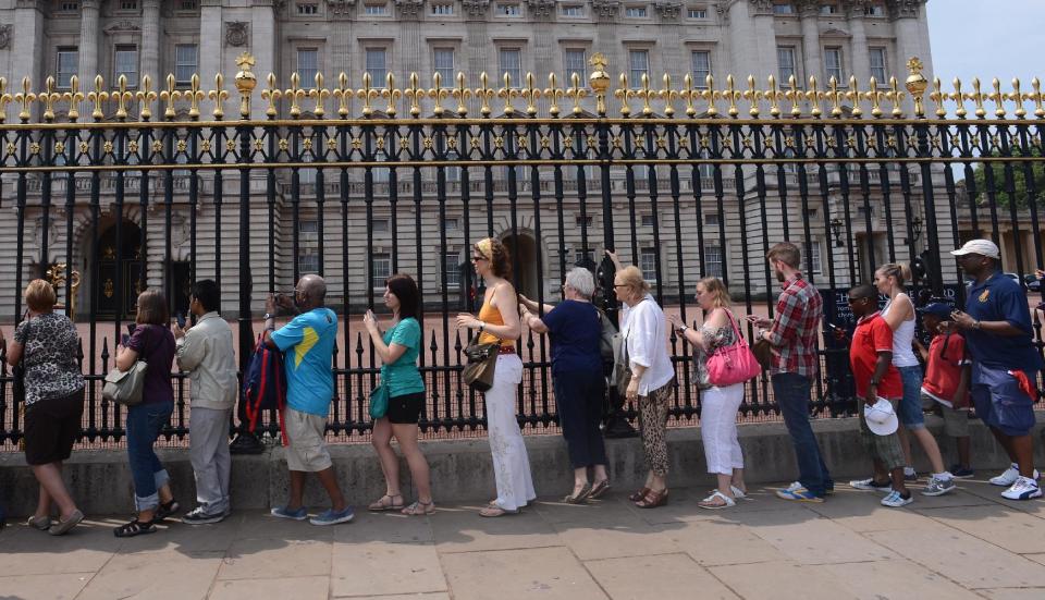 Members of the public queuing to look at the official announcement that the Duke and Duchess of Cambridge have had a baby boy, outside Buckingham Palace in London.