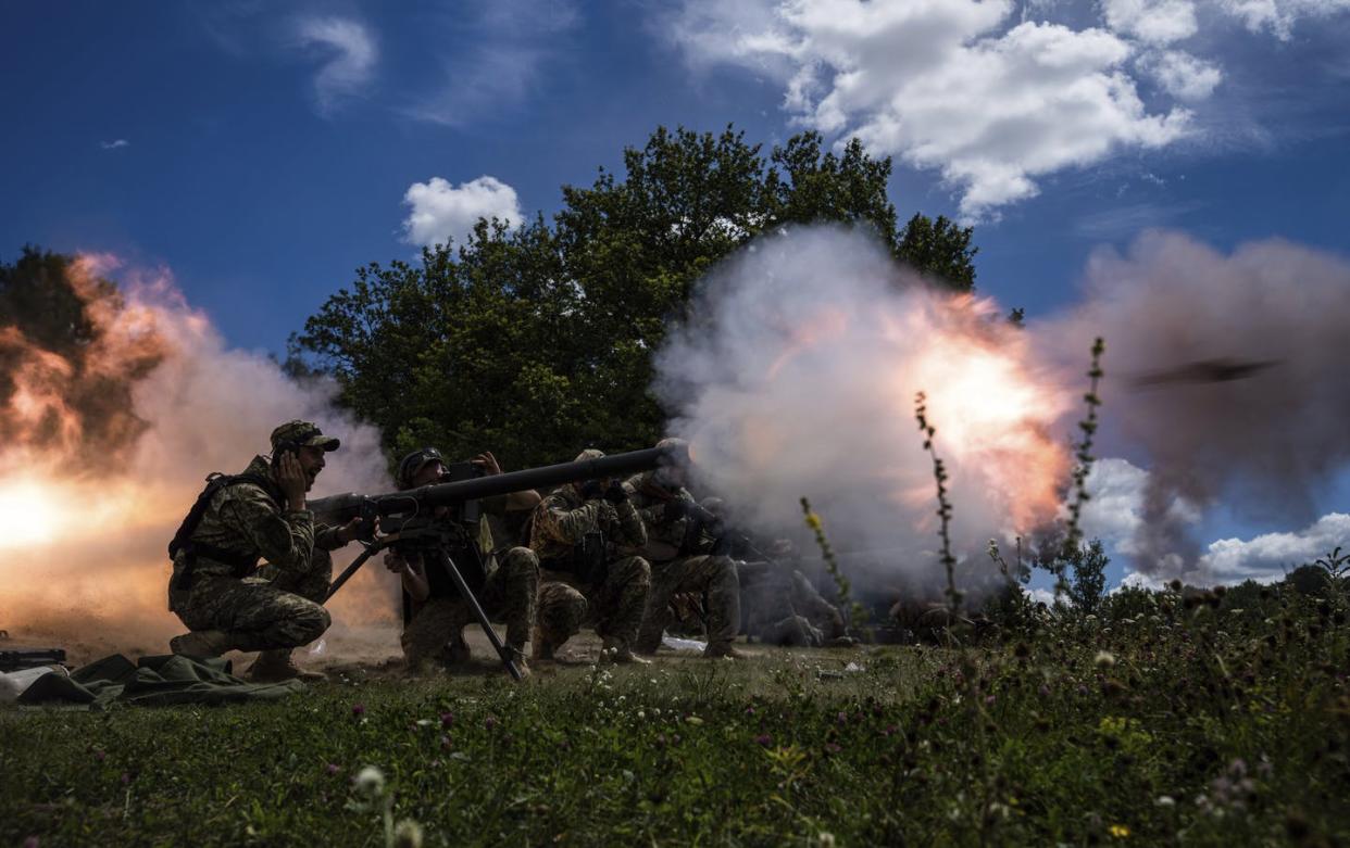 Ukrainian servicemen shoot with an SPG-9 recoilless gun during training in Kharkiv region, Ukraine, on July 19, 2022. (AP Photo/Evgeniy Maloletka)