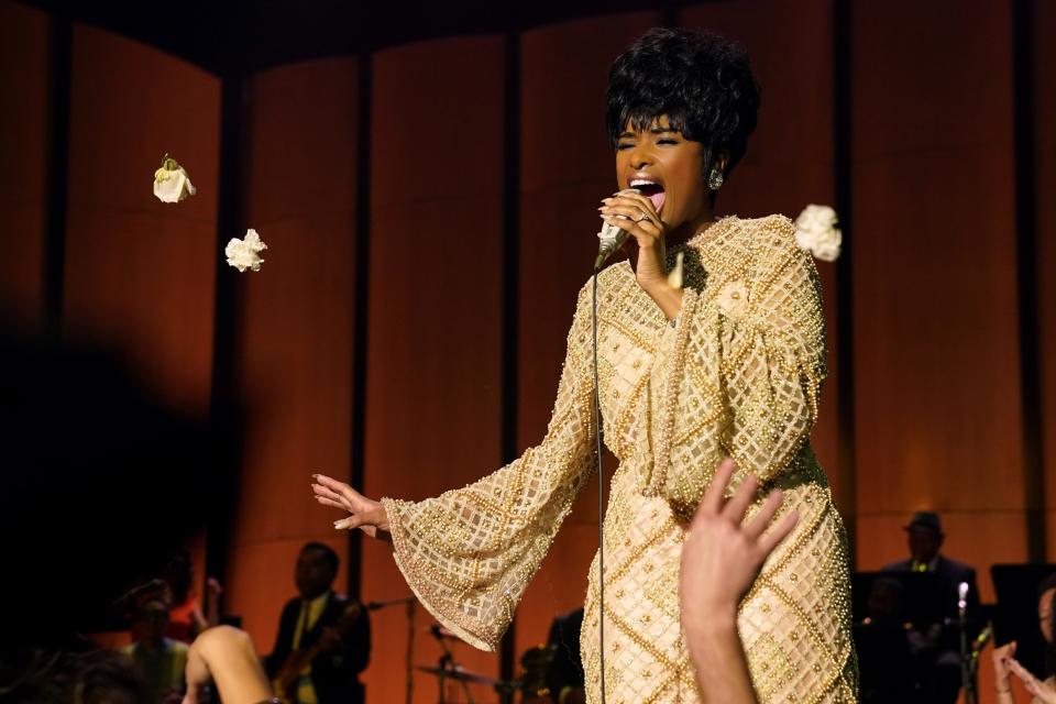 Jennifer Hudson sings into a microphone