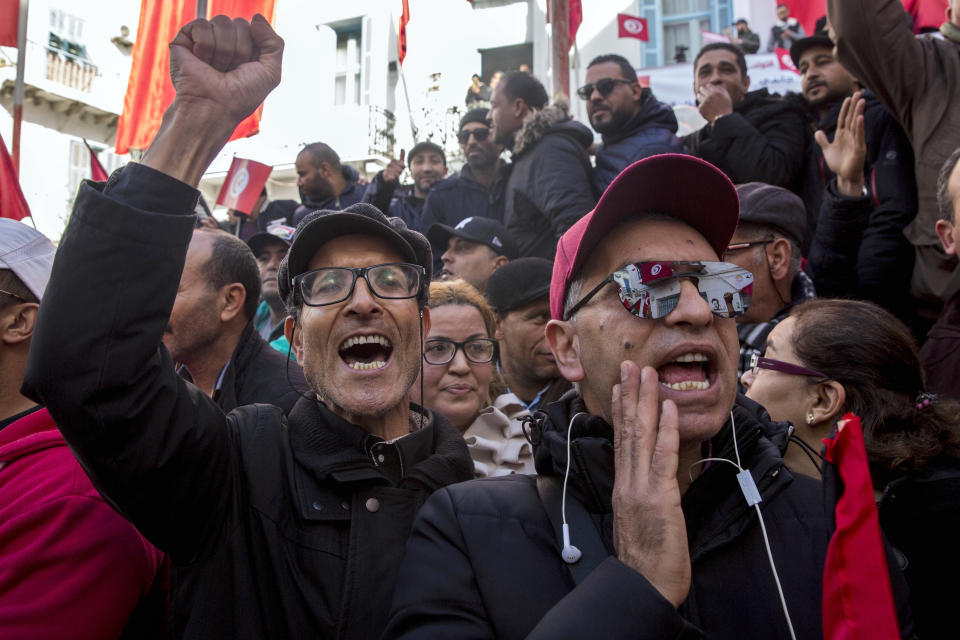 Tunisian workers stage a protest in front of the national union headquarters in the capital Tunis, Thursday, Jan. 17, 2019. Workers around Tunisia are on strike to demand higher pay in a standoff with a government struggling to tame unemployment, poverty and social tensions. (AP Photo/Hassene Dridi)