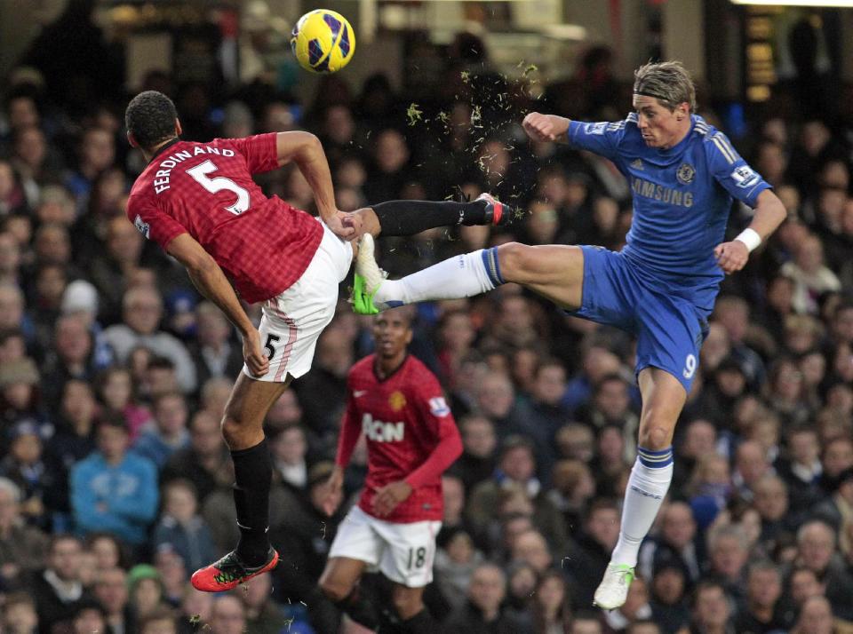 Chelsea's Fernando Torres, right, competes with Manchester United's Rio Ferdinand, during their English Premier League soccer match at Stamford Bridge, London, Sunday, Oct. 28, 2012. (AP Photo/Sang Tan)