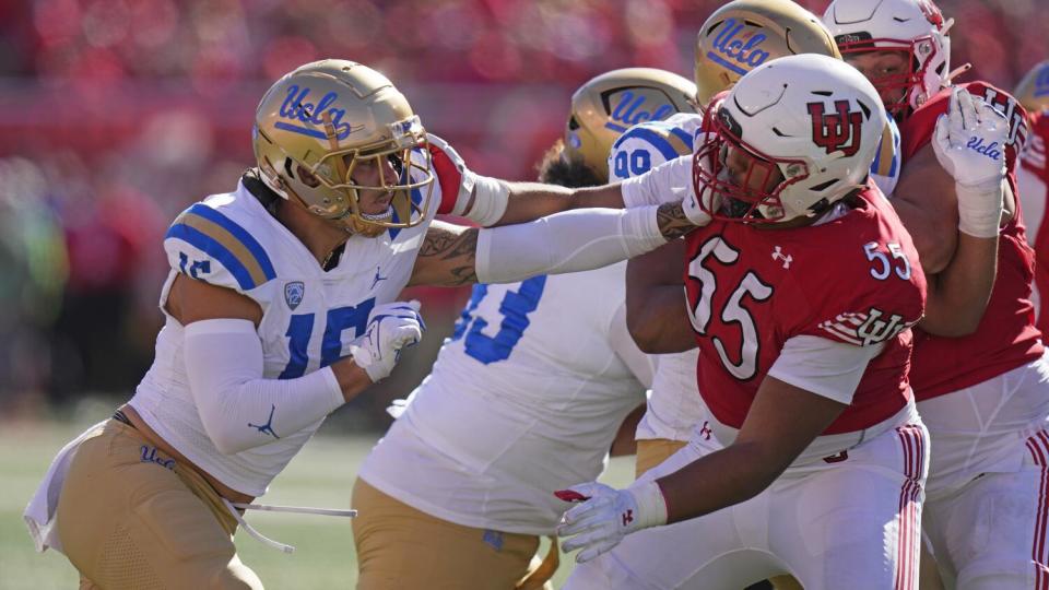 UCLA defensive lineman Laiatu Latu battles with Utah offensive lineman Spencer Fano for position