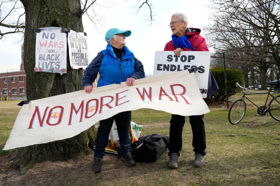 Lela Charney, of Leonia, and Afina Broekman, of Fair Lawn, hold signs outside of the Teaneck Armory.Wednesday, March 22, 2023