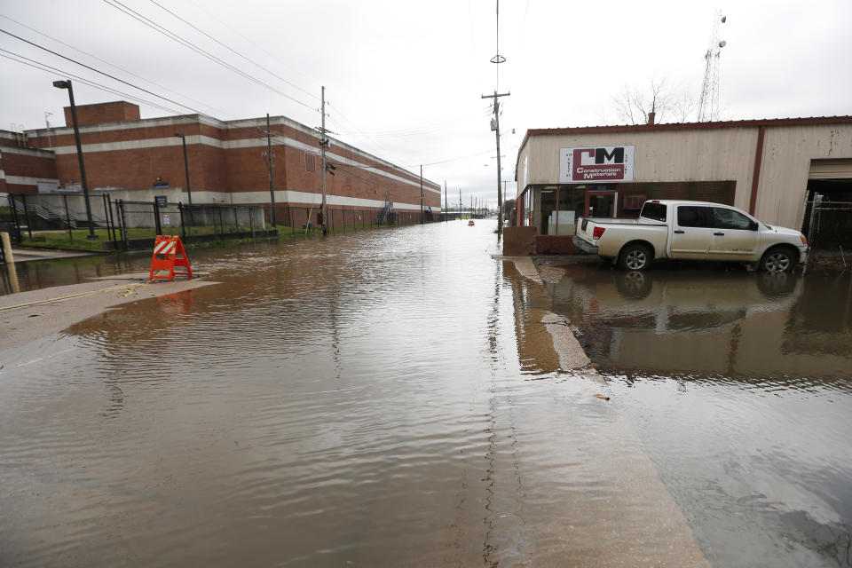 Floodwater from the Pearl River continues to flood downtown Jackson, Miss., including a construction business, right, and the main post office, left, Monday, Feb. 17, 2020. Authorities believe the flooding will rank as third highest, behind the historic floods of 1979 and 1983. (AP Photo/Rogelio V. Solis)