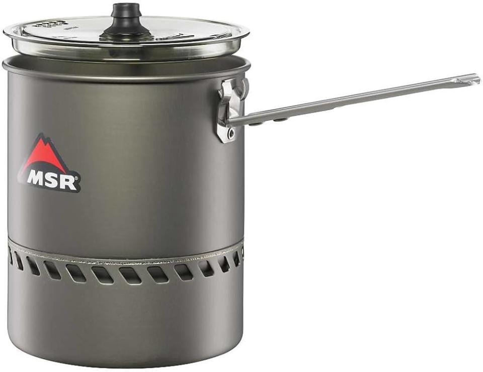 A grey camping cooking pot with a handle sits against a white background.