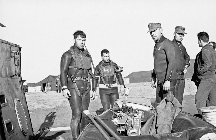 U.S., Navy frogmen arrive ashore with a LST to pickup a raft at the rescue and collection center set up in the beach in Palomares on Jan. 28, 1966, by U.S., Army and Air Force. The center has been set up to collect the pieces of the wreckage of a B-52 and a tanker jet which collided midair on January 17. They are also searching for nuclear devices which were aboard the B-52. One of the devices has been pinpointed at the bottom of the sea at about 1000mts offshore. (AP Photo/Franco Mattioli)