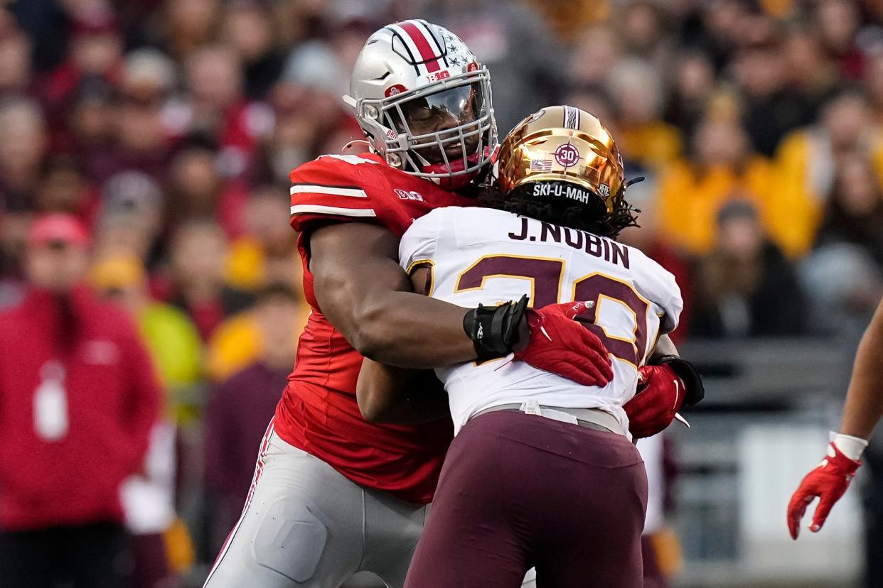 Nov 18, 2023; Columbus, Ohio, USA; Ohio State Buckeyes defensive tackle Ty Hamilton (58) tackles Minnesota Golden Gophers running back Jordan Nubin (30) during the first half of the NCAA football game at Ohio Stadium.