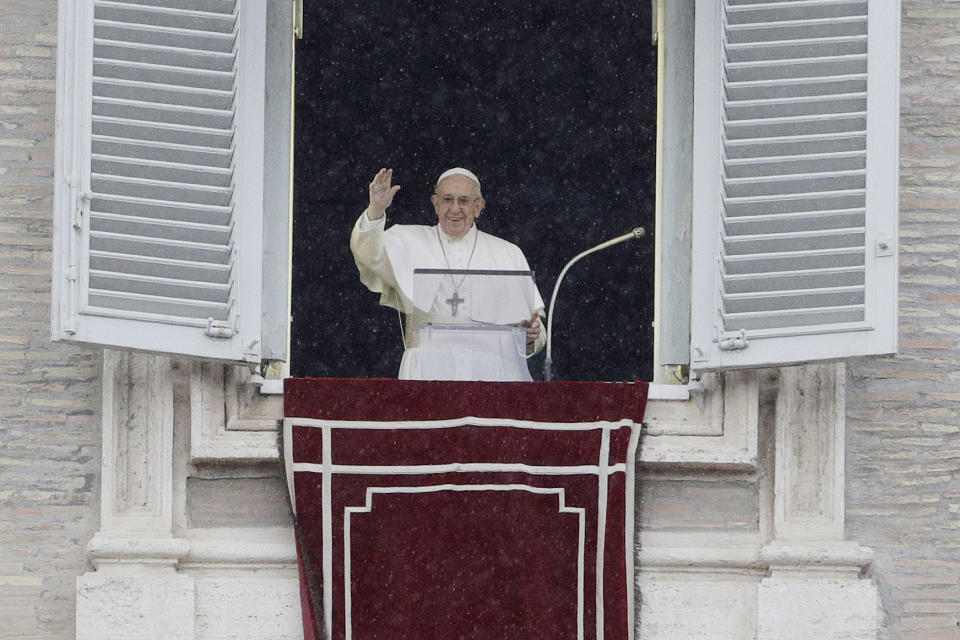 Pope Francis waves to faithful during the Angelus noon prayer he delivered from his studio's window overlooking St. Peter's Square at the Vatican, Sunday, Nov. 4, 2018. (AP Photo/Gregorio Borgia)