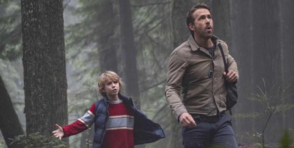 Walker Scobell in a vest, Ryan Reynolds in a cream jacket