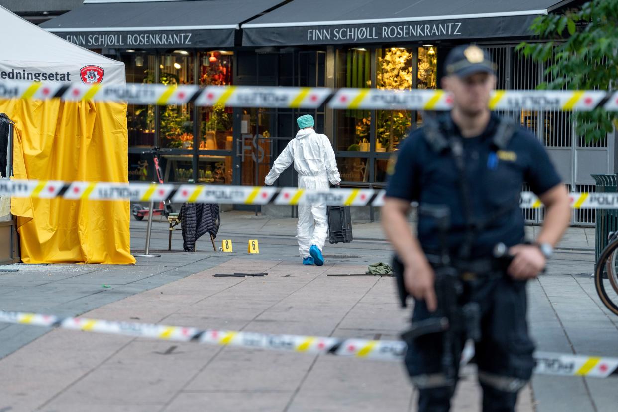 Police investigate at the scene of a shooting in central Oslo, on Saturday killed two people and injured more than a dozen.