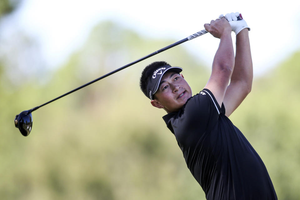 Carl Yuan of China watches his shot from the second tee box during the third day of the Sanderson Farms Championship golf tournament in Jackson, Miss., Saturday, Oct 7, 2023. (James Pugh/impact601.com via AP)