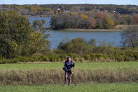 Metal detectorist Denise Schoener, of Hanson, Mass., searches for historic coins and artifacts in a farm field in Little Compton, R.I., Thursday, Oct. 27, 2022. One coin at a time, the ground is yielding new evidence that in the late 1600s, Henry Every, one of the world's most ruthless pirates, wandered the American colonies with impunity. Schoener found a 17th century silver coin with Arabic inscriptions in 2019 in a field in Little Compton. (AP Photo/Steven Senne)