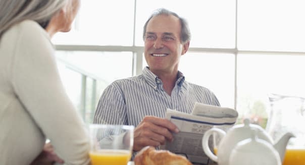 Smiling senior couple at breakfast table