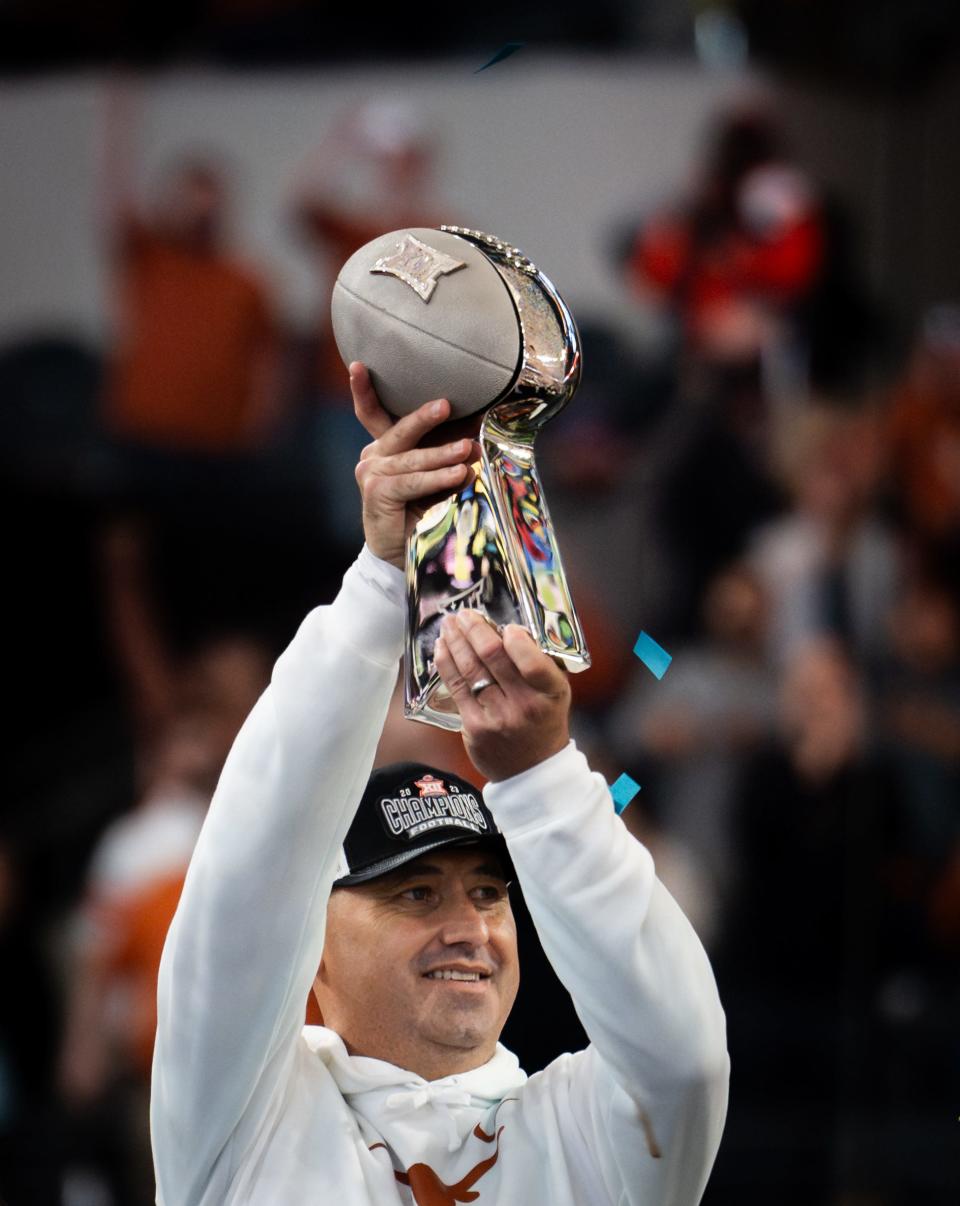 Texas coach Steve Sarkisian raises the Big 12 championship trophy after beating Oklahoma State earlier this month. Late Wednesday, Sarkisian and the Texas staff flipped linebacker prospect Tyanthony Smith to complete a 22-player haul on early national signing day.