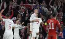 Poland's Karol Swiderski celebrates after scoring his side's opening goal during the UEFA Nations League soccer match between Wales and Poland at the Cardiff City Stadium in Cardiff, Wales, Sunday, Sept. 25, 2022. (AP Photo/Frank Augstein)