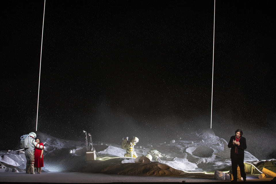 Soprano Ailyn Pérez as Mimi, in red at left, and tenor Joshua Guerrero right, appear during the final dress rehearsal of a revival of Claus Guth’s production of Puccini’s “La Bohème” at Paris’ Opéra Bastille, on on April 29, 2023. (Opéra national de Paris via Associated Press)