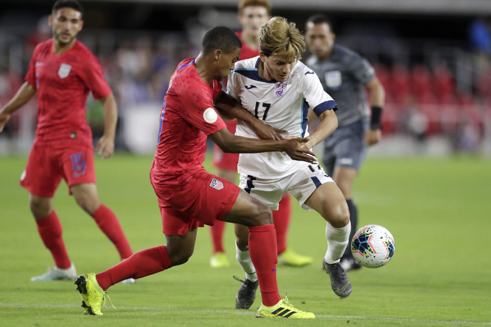 Cuba's Jean Carlos Rodriguez, right, and United States' Reggie Cannon compete for the ball during the first half of a CONCACAF Nations League soccer match Friday, Oct. 11, 2019, in Washington. (AP Photo/Julio Cortez)