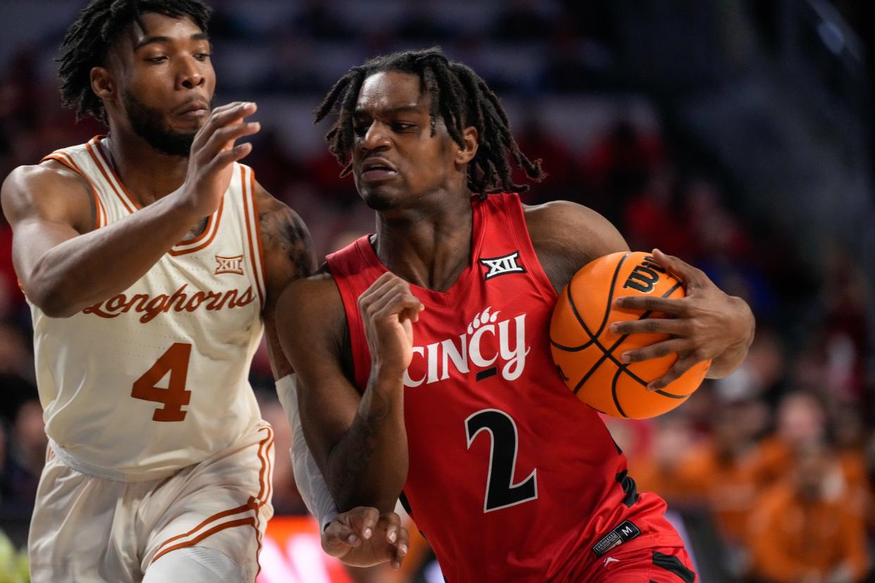 Guard Jizzle James  drives against Texas guard Tyrese Hunter in the second half. James is UC's fifth-leading scorer (8.5 points) while being eighth on the team in minutes played.