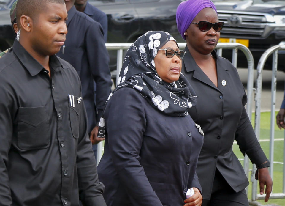 FILE - In this March 20, 2021 file photo, Tanzania's new President Samia Suluhu Hassan, center, arrives to pay her respects as the body of former president John Magufuli lies in state at Uhuru stadium in Dar es Salaam, Tanzania. Tanzania has received its first batch of 1 million Johnson & Johnson COVID-19 vaccines donated by the U.S. Tanzania had been among the few countries in Africa yet to receive vaccines or start vaccinating its population, mainly because its former leader had claimed prayer had defeated COVID-19 in the country. (AP Photo, File)