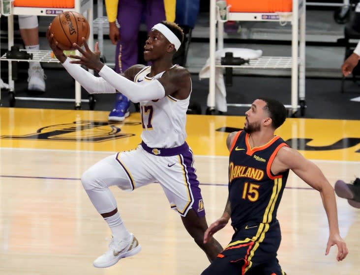 LOS ANGELES, CALIF. - FEB. 28, 2021. Lakers guard Dennis Schroder slices to the basket against Warriors guard Mychal Mulder in the first quarter of Sunday night's game, Feb. 28, 2020, at Staples Center in Los Angeles. (Luis Sinco/Los Angeles Times)