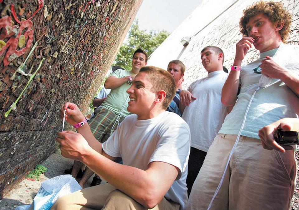 Cal Poly freshmen participating in Week of Welcome leave their mark on Bubblegum Alley during a tour of downtown San Luis Obispo in 2006.