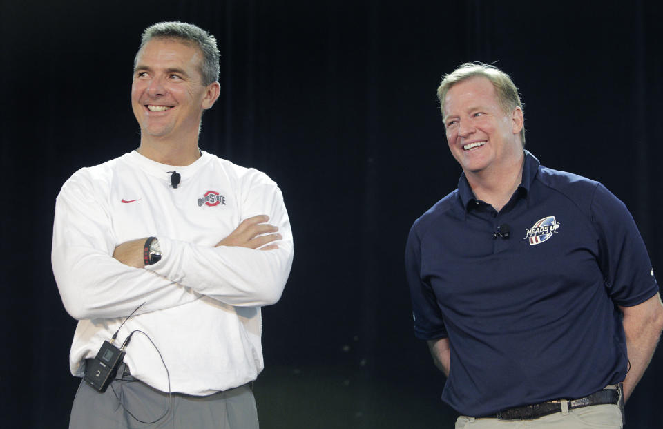 FILE - NFL Commissioner Roger Goodell, right, and Ohio State NCAA college football head coach Urban Meyer answer questions during a safety clinic for mothers of youth football players in Columbus, Ohio, in this Thursday, Aug. 1, 2013, file photo. A person familiar with the search says Urban Meyer and the Jacksonville Jaguars are working toward finalizing a deal to make him the team's next head coach. The person spoke to The Associated Press on the condition of anonymity Thursday, Jan. 14, 2021, because a formal agreement was not yet in place. (AP Photo/Jay LaPrete, File)