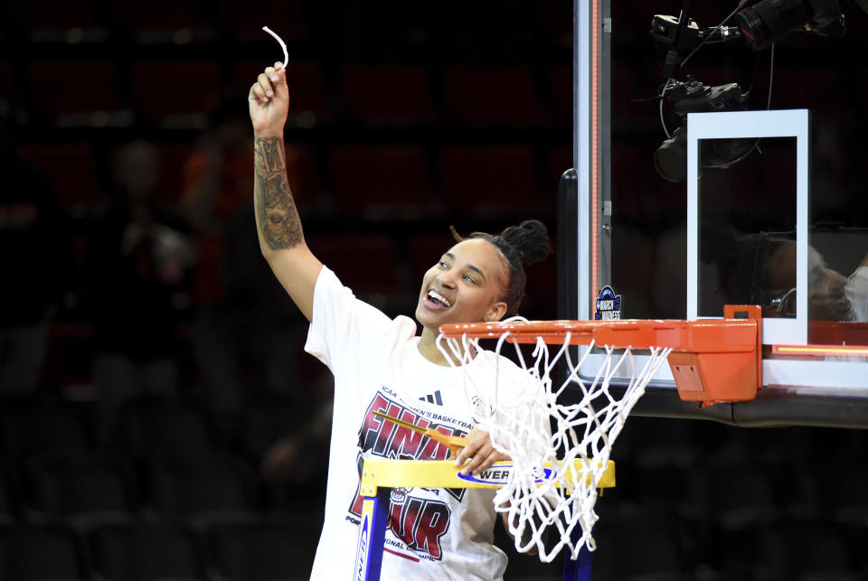 North Carolina State guard Aziaha James holds up a piece of the net after the team's win over Texas in an Elite Eight college basketball game in the women's NCAA Tournament, Sunday, March 31, 2024, in Portland, Ore. (AP Photo/Steve Dykes)